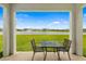 Relaxing patio overlooking a serene pond with a fountain and landscaped community at 5644 Flagstone Trl, Palmetto, FL 34221