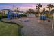 Community playground with swings, slides, and climbing wall at 5644 Flagstone Trl, Palmetto, FL 34221