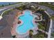 Aerial view of a unique community pool with palm trees and seating areas at 5644 Flagstone Trl, Palmetto, FL 34221
