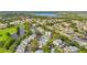 Aerial view of the community featuring lush landscaping, homes, pool, and scenic lake creating a serene residential setting at 6310 Green Oak Cir, Bradenton, FL 34203