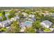 Aerial view of the community featuring lush landscaping, homes, pool, and scenic lake creating a serene residential setting at 6310 Green Oak Cir, Bradenton, FL 34203