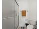 Bathroom featuring a shower with frosted glass doors, a toilet, and a towel rack at 6310 Green Oak Cir, Bradenton, FL 34203
