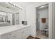 Bathroom featuring white vanity, a large mirror, and glass shower doors at 6310 Green Oak Cir, Bradenton, FL 34203