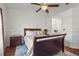 Bedroom featuring a ceiling fan, wood flooring, and a decorative bed with a dark wood frame at 6310 Green Oak Cir, Bradenton, FL 34203