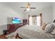 Bedroom featuring hardwood floors, dark furniture and a flat screen tv at 6310 Green Oak Cir, Bradenton, FL 34203