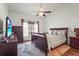 Bedroom with dark wood furniture, a ceiling fan, and a bright window at 6310 Green Oak Cir, Bradenton, FL 34203