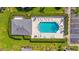 Aerial shot shows community swimming pool surrounded by lounge chairs and landscaped grounds, with nearby buildings at 6310 Green Oak Cir, Bradenton, FL 34203