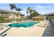 Enjoy this lovely swimming pool area with lounge chairs and shaded tables, perfect for relaxation or entertainment at 6310 Green Oak Cir, Bradenton, FL 34203