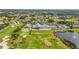An aerial view of the golf course, driving range, and clubhouse amenities, including a pool, tennis courts, and bocce ball at 6310 Green Oak Cir, Bradenton, FL 34203