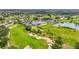 Aerial shot showcasing the golf course and country club, surrounded by verdant greenery and residential housing with mature trees at 6310 Green Oak Cir, Bradenton, FL 34203