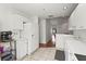 Open kitchen area with white cabinets, appliances, and tile flooring at 6310 Green Oak Cir, Bradenton, FL 34203