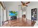 Bright living room with hardwood floors, high ceilings and a large TV at 6310 Green Oak Cir, Bradenton, FL 34203