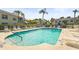 Inviting community pool with lounge chairs, umbrellas and white fencing at 6310 Green Oak Cir, Bradenton, FL 34203