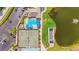 Top-down shot showing a swimming pool and tennis courts, highlighting community recreational amenities, parking, and a bocce ball court at 6310 Green Oak Cir, Bradenton, FL 34203