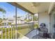Enjoy the view from this screened porch with a ceiling fan and outdoor seating, overlooking the community pool and landscaping at 6310 Green Oak Cir, Bradenton, FL 34203