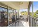 This tiled, screened porch features sliding doors and offers a comfortable space with chairs and table to relax outdoors at 6310 Green Oak Cir, Bradenton, FL 34203