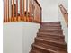 Elegant wooden staircase with a classic railing and white walls at 6310 Green Oak Cir, Bradenton, FL 34203