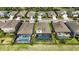 Aerial view showcases multiple homes with screened-in pools, manicured lawns, and neighborhood streets at 6377 Mighty Eagle Way, Sarasota, FL 34241