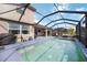Home's backyard features a pool with screened-in patio, as well as a grill and outdoor dining space at 6377 Mighty Eagle Way, Sarasota, FL 34241