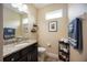 Cozy half-bath featuring a granite countertop and a decorative mirror at 6377 Mighty Eagle Way, Sarasota, FL 34241