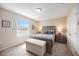 Charming bedroom with a queen bed, soft lighting, and views of the outdoors at 6377 Mighty Eagle Way, Sarasota, FL 34241