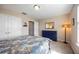 Cozy bedroom featuring a queen bed, blue dresser, and closet at 6377 Mighty Eagle Way, Sarasota, FL 34241