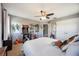 Spacious bedroom featuring a ceiling fan, artwork, arcade game, and ample natural light at 6377 Mighty Eagle Way, Sarasota, FL 34241