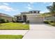 Charming two-story home features a well-manicured lawn and a spacious two-car garage at 6377 Mighty Eagle Way, Sarasota, FL 34241