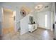 Inviting foyer with tile flooring, white walls, and decorative compass rose wall hanging at 6377 Mighty Eagle Way, Sarasota, FL 34241
