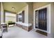 Inviting front porch with stone accents, a dark wood door and a new grill at 6377 Mighty Eagle Way, Sarasota, FL 34241