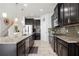 Modern kitchen features dark cabinets, granite countertops, stainless steel appliances at 6377 Mighty Eagle Way, Sarasota, FL 34241