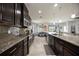 Well-equipped kitchen boasts stainless steel appliances, granite counters, and dark wood cabinets at 6377 Mighty Eagle Way, Sarasota, FL 34241