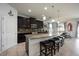 Stylish kitchen with dark cabinetry, granite countertops, and a breakfast bar with seating at 6377 Mighty Eagle Way, Sarasota, FL 34241