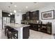 Kitchen with dark wood cabinets, granite countertops, stainless steel appliances, and large island with seating at 6377 Mighty Eagle Way, Sarasota, FL 34241
