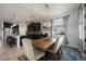 Open kitchen and dining area with dark cabinets, granite counters, island seating and stylish light fixtures at 6377 Mighty Eagle Way, Sarasota, FL 34241
