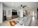 Living room with ceiling fan, gray sofa, neutral decor, and staircase view at 6377 Mighty Eagle Way, Sarasota, FL 34241