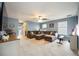 Spacious living room with a plush sectional sofa, carpet flooring, and a ceiling fan at 6377 Mighty Eagle Way, Sarasota, FL 34241