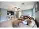 Comfortable living room with a large sectional sofa, TV, fan and stylish console at 6377 Mighty Eagle Way, Sarasota, FL 34241