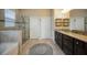 Elegant main bathroom with a soaking tub, glass-enclosed shower, and dual vanity at 6377 Mighty Eagle Way, Sarasota, FL 34241
