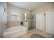 Bright main bathroom with a separate tub and shower, tile surround and natural light at 6377 Mighty Eagle Way, Sarasota, FL 34241