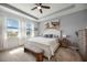 Serene main bedroom with a tray ceiling, large windows, and neutral colors at 6377 Mighty Eagle Way, Sarasota, FL 34241