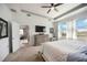 Airy main bedroom featuring a tray ceiling, ample windows, and a mounted TV at 6377 Mighty Eagle Way, Sarasota, FL 34241