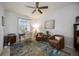 Office with desk, armchairs, ceiling fan, and large area rug at 6377 Mighty Eagle Way, Sarasota, FL 34241