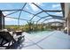 Stunning backyard pool surrounded by a screened-in patio, landscaping, and comfortable seating at 6377 Mighty Eagle Way, Sarasota, FL 34241