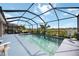 Beautiful pool with screened-in patio, landscaping, and comfortable lounge seating at 6377 Mighty Eagle Way, Sarasota, FL 34241