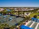 An aerial view showcases tennis courts, bocce ball, parking, and homes in this community at 6714 Alstead Cir, Bradenton, FL 34202