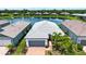 Aerial view of a single-Gathering home with lush landscaping and serene water views in a Primary-planned community at 6714 Alstead Cir, Bradenton, FL 34202