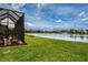 Scenic view of the lake from the screened-in lanai and lush backyard of this home at 6714 Alstead Cir, Bradenton, FL 34202