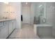 Modern bathroom featuring tiled floors, white cabinets, quartz countertop, and a glass shower at 6714 Alstead Cir, Bradenton, FL 34202