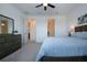 Comfortable bedroom with a ceiling fan and ensuite bathroom access and a gray dresser at 6714 Alstead Cir, Bradenton, FL 34202
